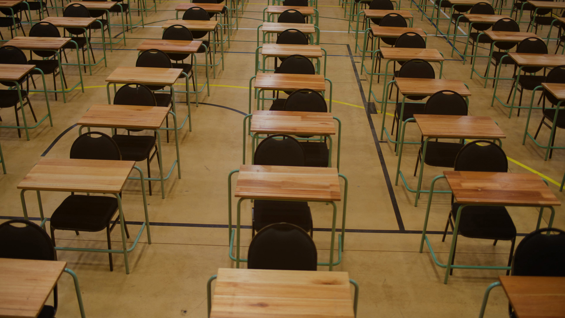 An exam hall, with tables and chairs in rows